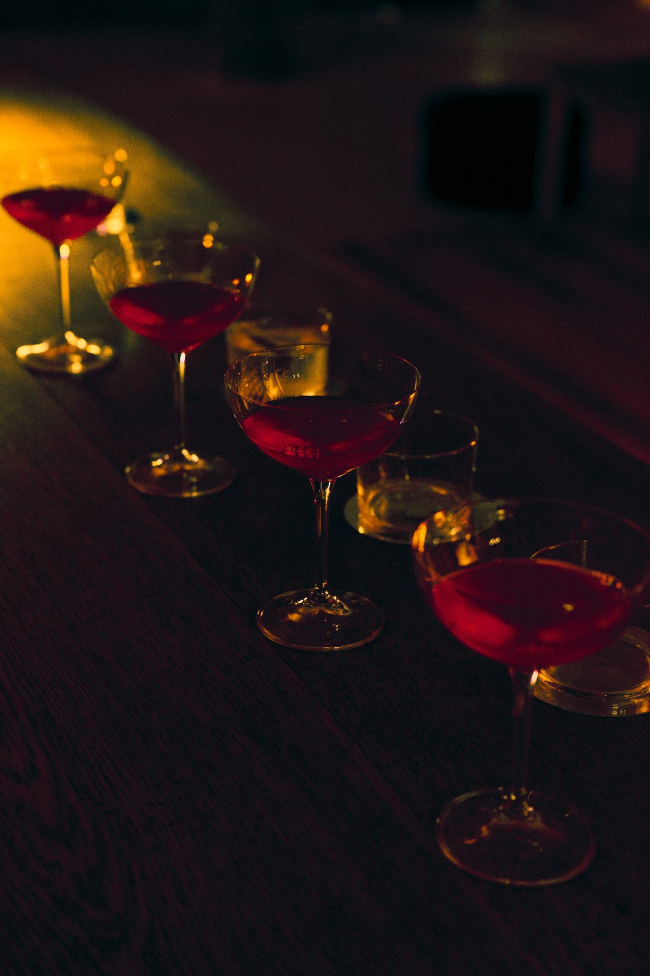 Copas coupé con trago rojo sobre la barra, lanzamiento Stella McCartney × H&M