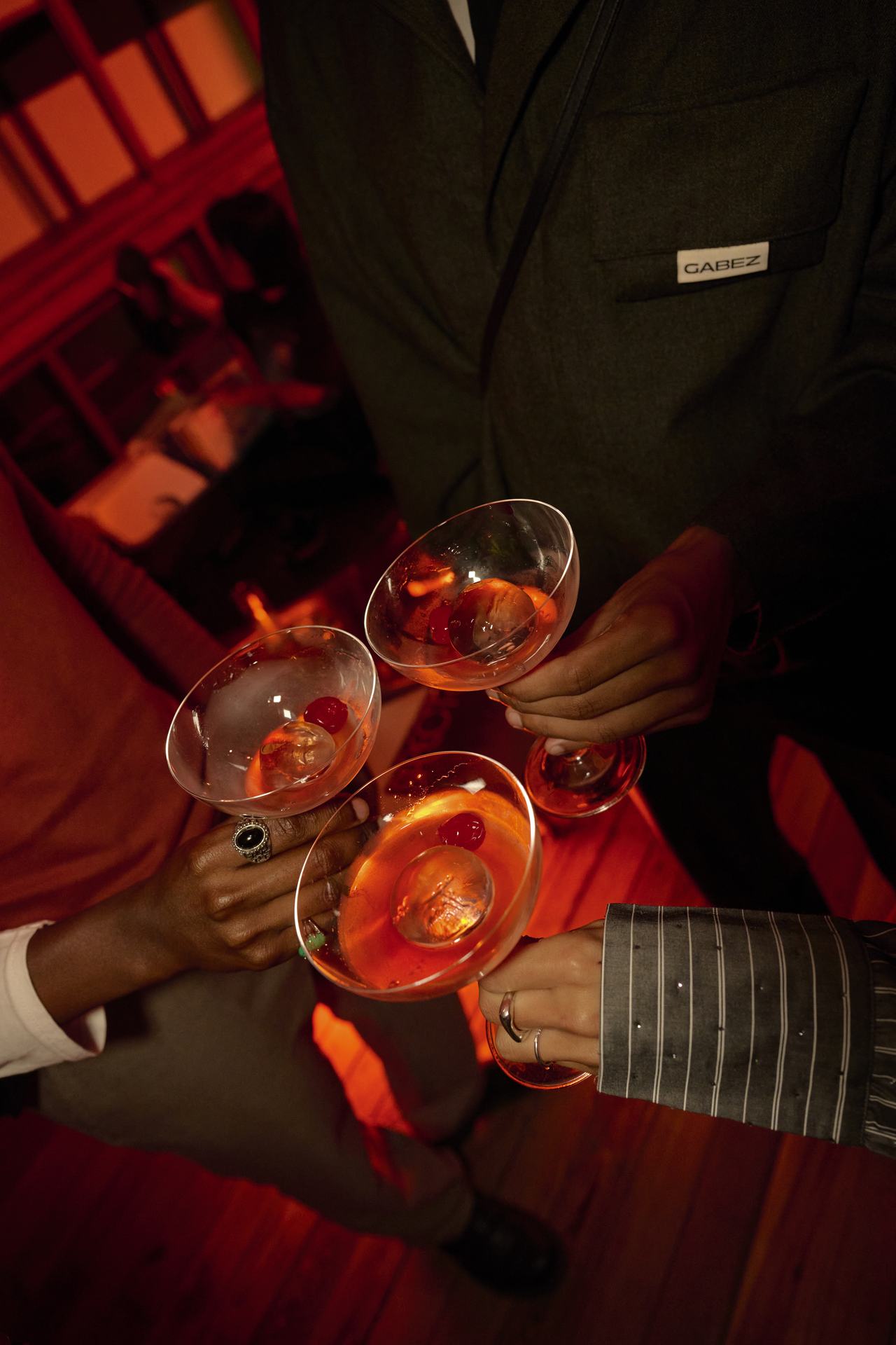 Invitados brindando con copas de cóctel, lanzamiento Stella McCartney × H&M